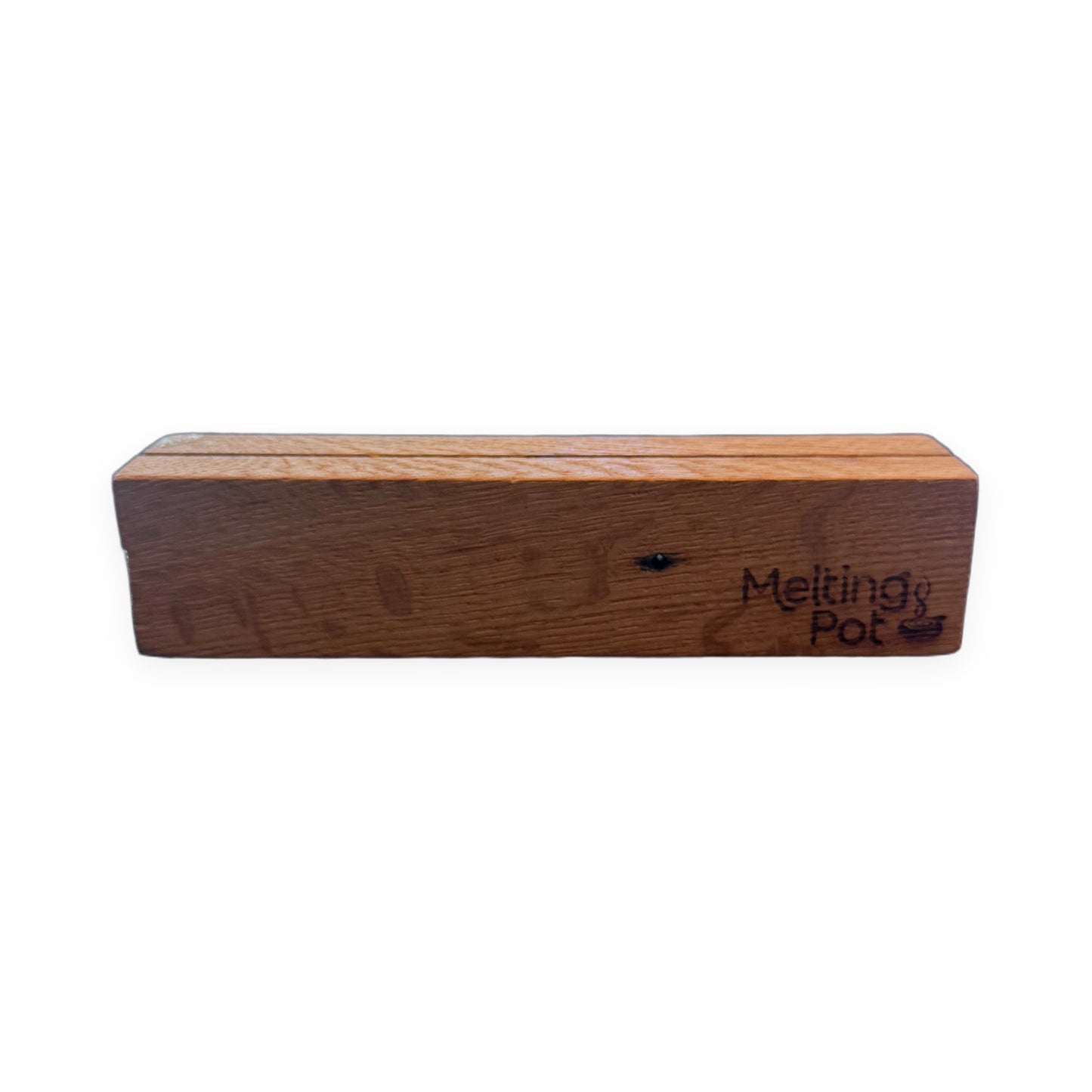 Reclaimed wood picture frame, top-down view of the engraved Melting Pot logo on the base