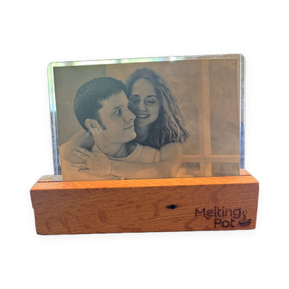 Reclaimed wood picture frame with engraved Melting Pot logo, holding a black and white couple photo