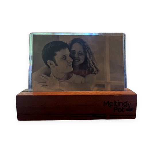 Reclaimed wood picture frame with engraved Melting Pot logo, holding a sepia-toned engagement photo